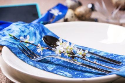 Easter Table Setting With Blue Textile Napkin, Blossom Branch And Quail Eggs