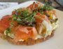 Andrei's Salmon Toast - Gravlax, free-range California egg salad, tomato, shaved red onion, capers, and grilled sourdough bread